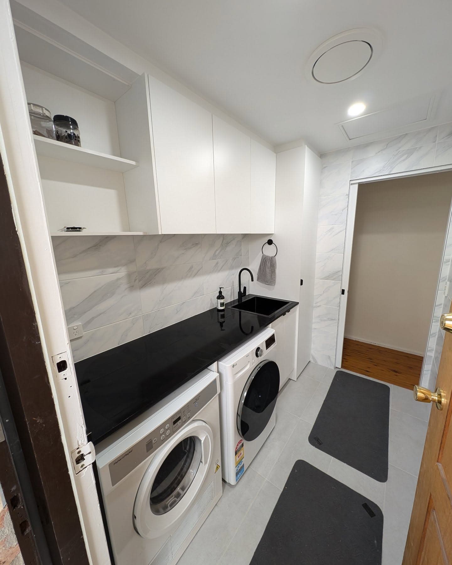 Renovated bathroom with double timber vanity and grey tiling